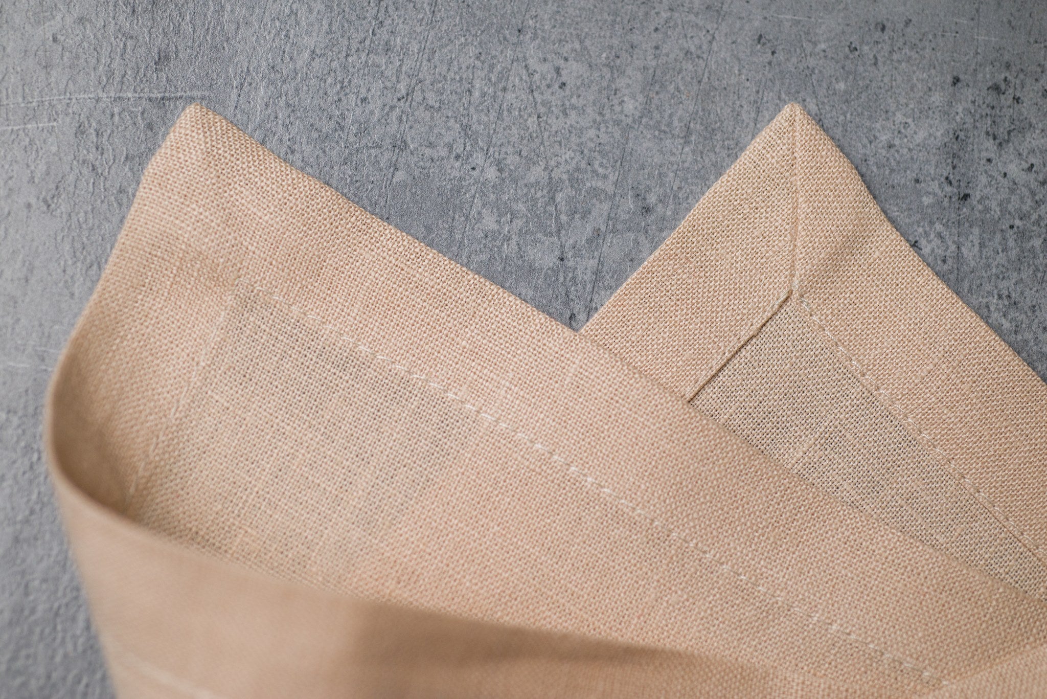 Sand linen fabric close-up with mitered hem corner – CoolLinen color 45. Sand