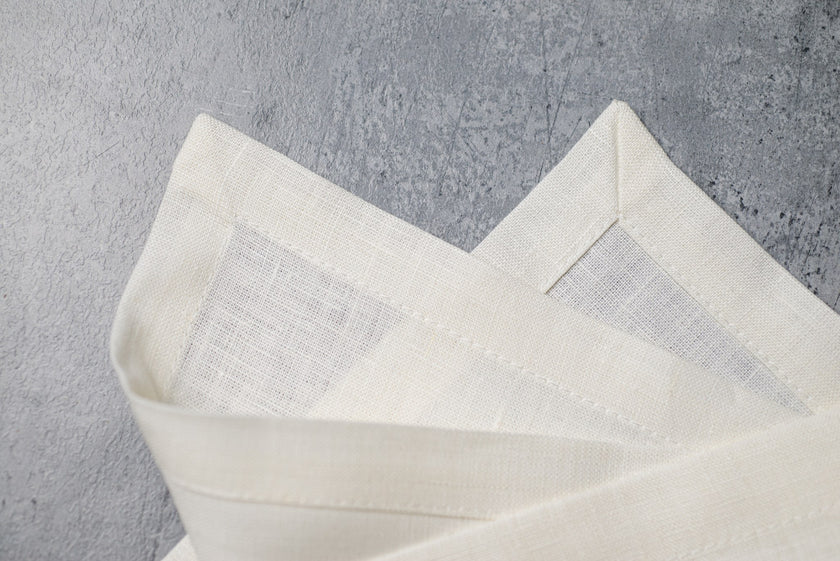 Milk linen fabric close-up with mitered hem corner – CoolLinen color 47. Milk