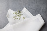 White linen fabric close-up with mitered hem corner – CoolLinen color 49. White