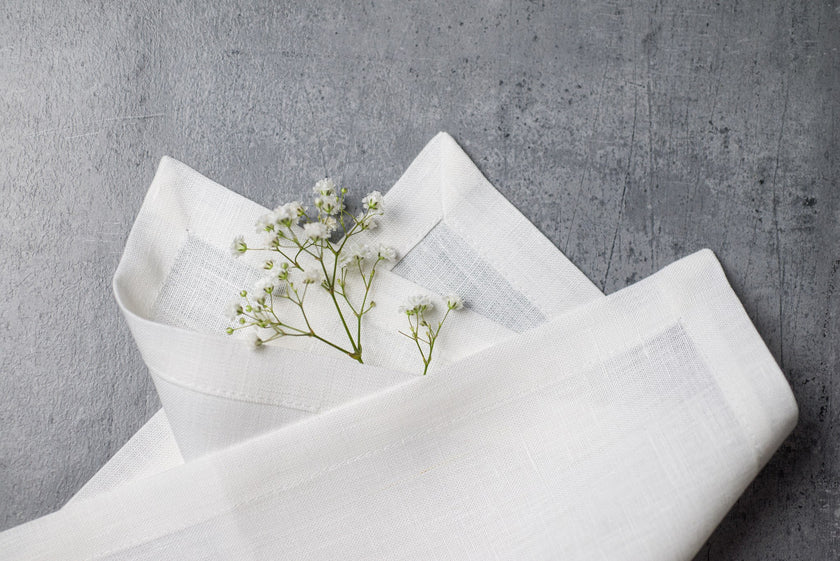 White linen fabric close-up with mitered hem corner – CoolLinen color 49. White