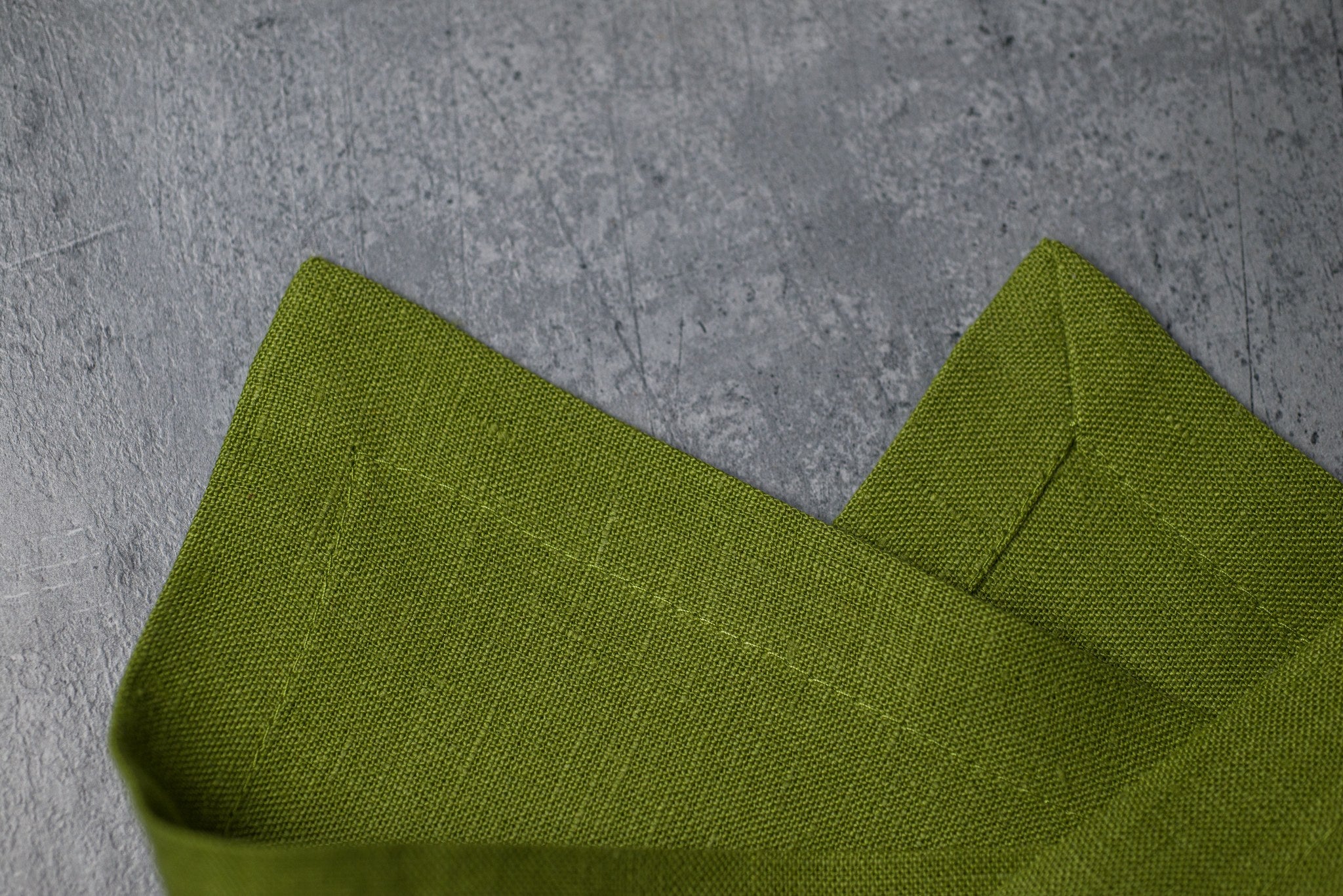 Pear linen fabric close-up with mitered hem corner – CoolLinen color 54. Pear