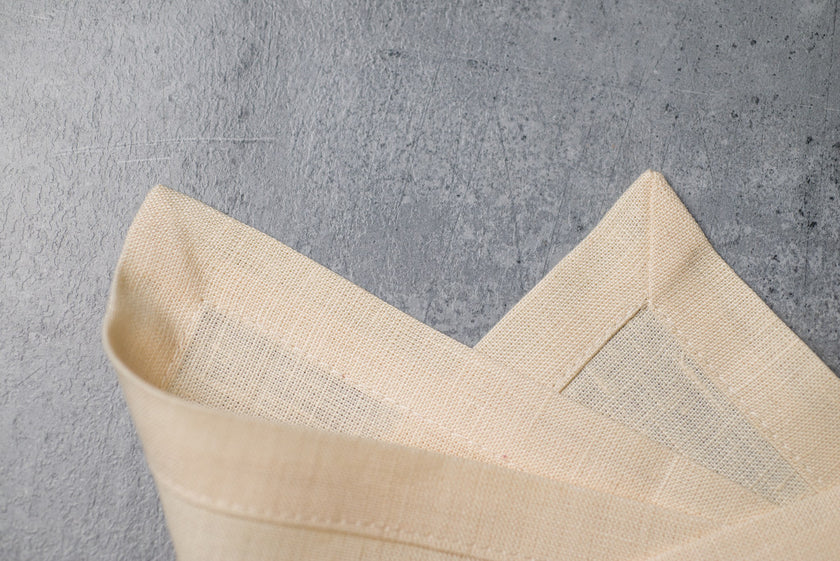 Cream linen fabric close-up with mitered hem corner – CoolLinen color 61. Cream