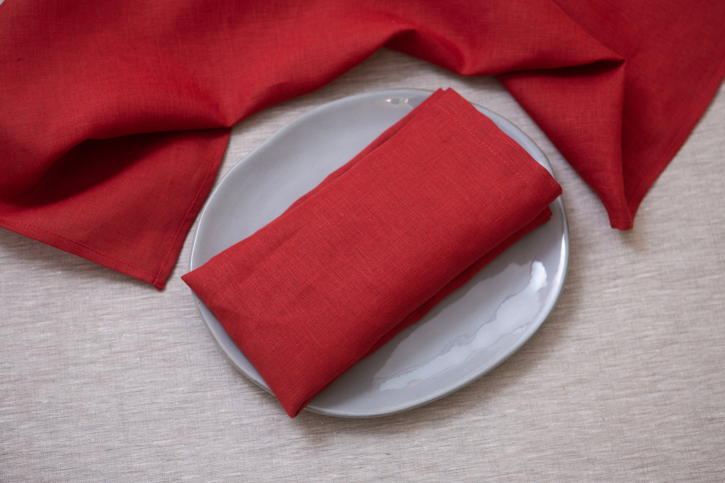 These linen napkins in classic red color with mitered corners are a timeless addition to any table setting. The vibrant red shade brings a bold and captivating presence, adding a touch of elegance and warmth to your dining experience. Made from high-quality linen fabric, these napkins offer a luxurious and soft feel, ensuring both comfort and durability.